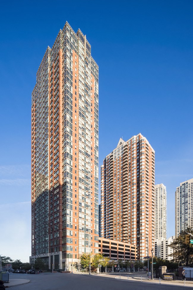 a tall building in a city with other tall skyscrapers