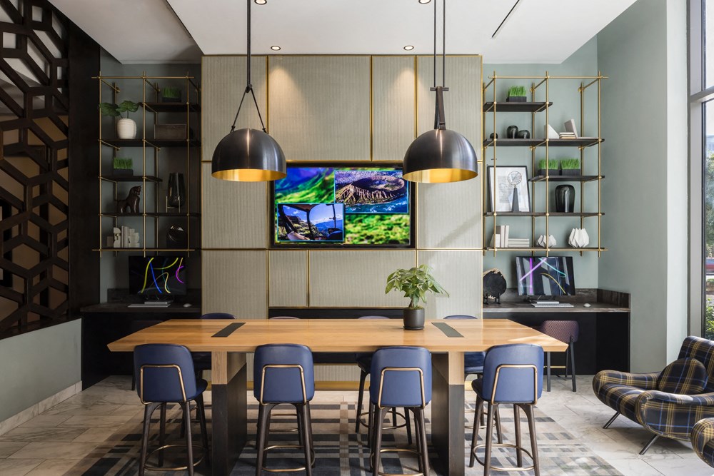 A modern dining area with a wooden table and blue chairs.
