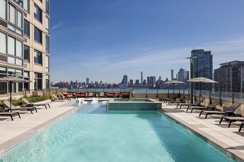 a pool with a view of the skyline in the background of a