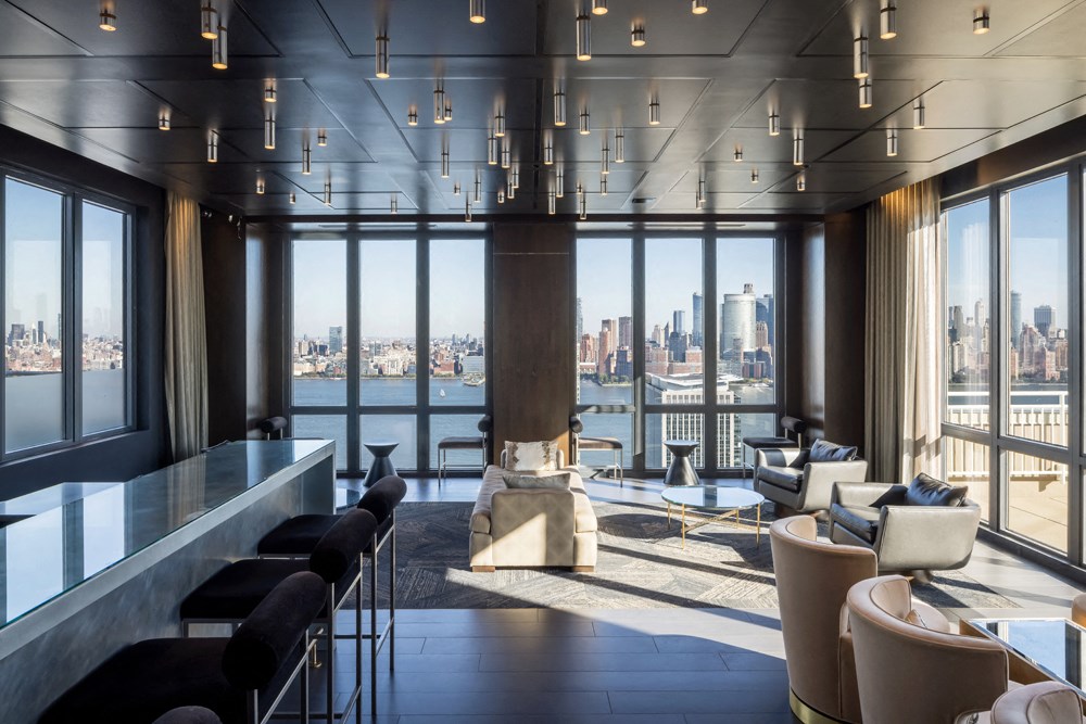 A modern living room with a view of the city skyline.