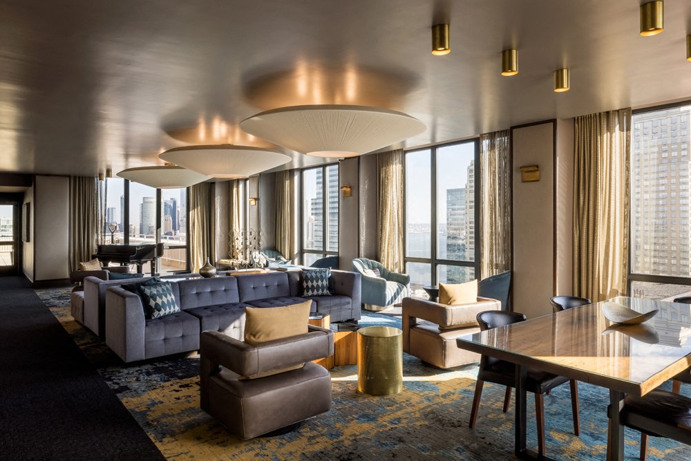 A modern living room with a large window and a view of the city.