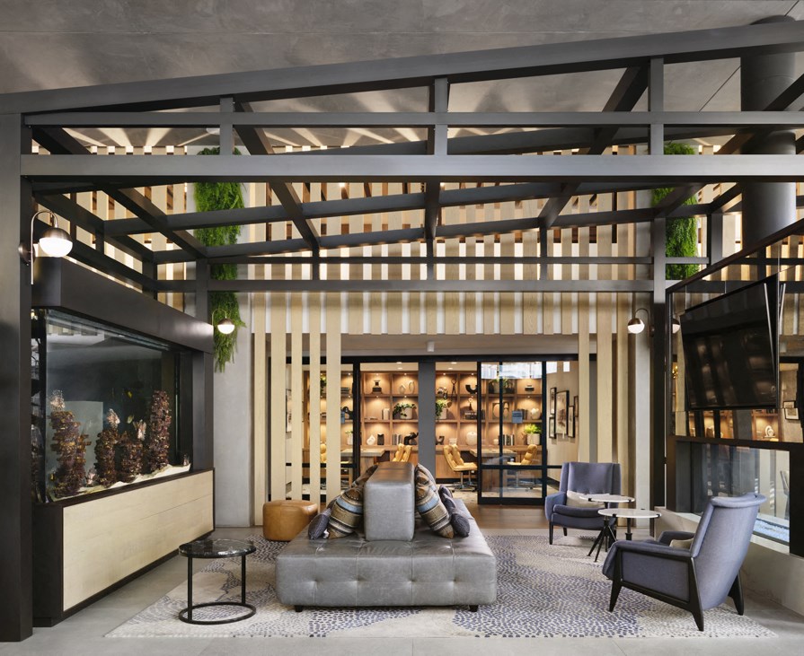 the lobby of a hotel with a couch and chairs