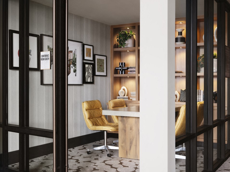 a room with a desk and a chair and a window