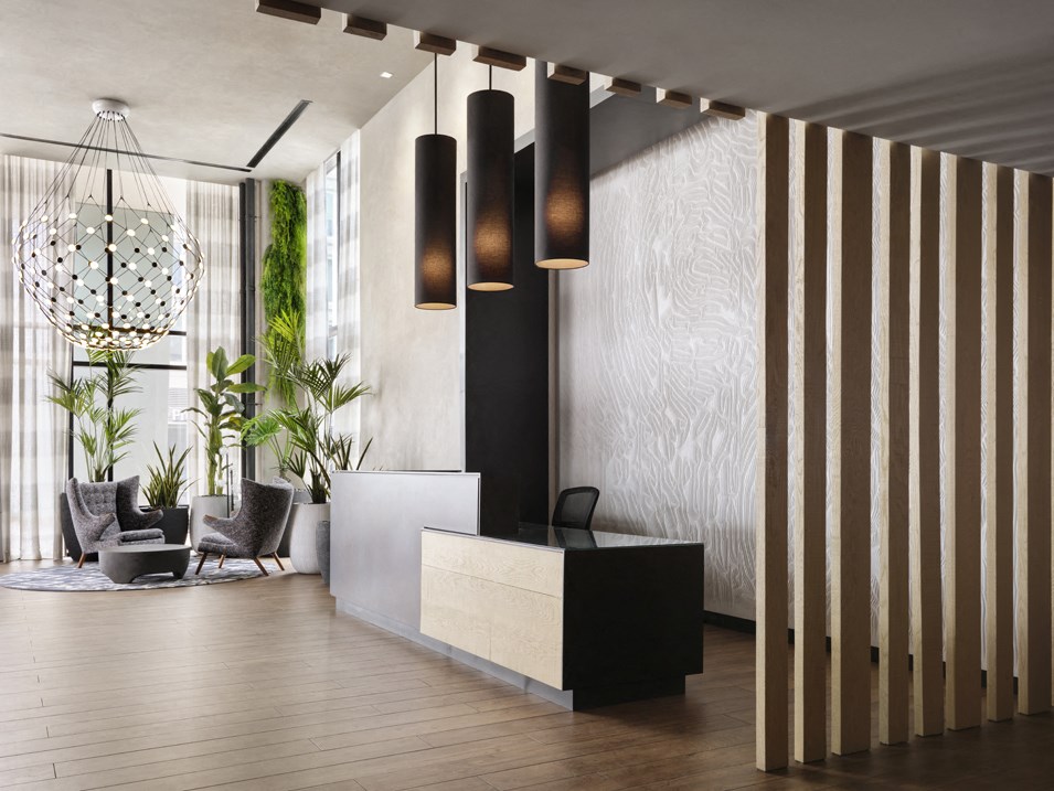 a lobby with a reception desk and a large window