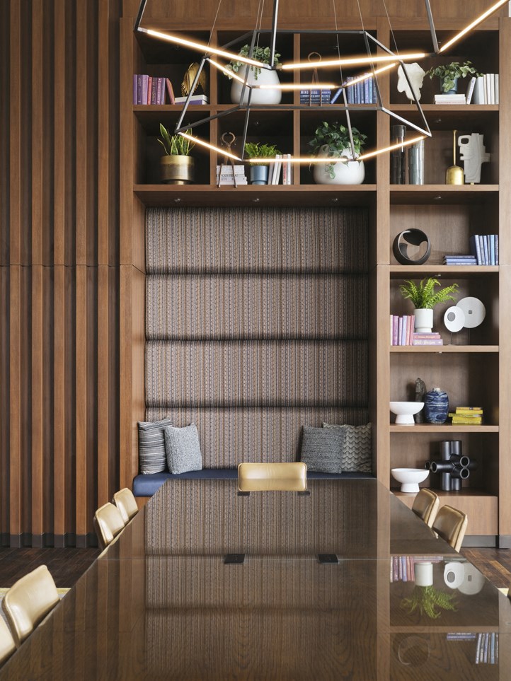 a room with a desk and shelves and a chair