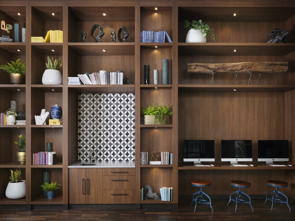 a home office with wooden shelves and stools