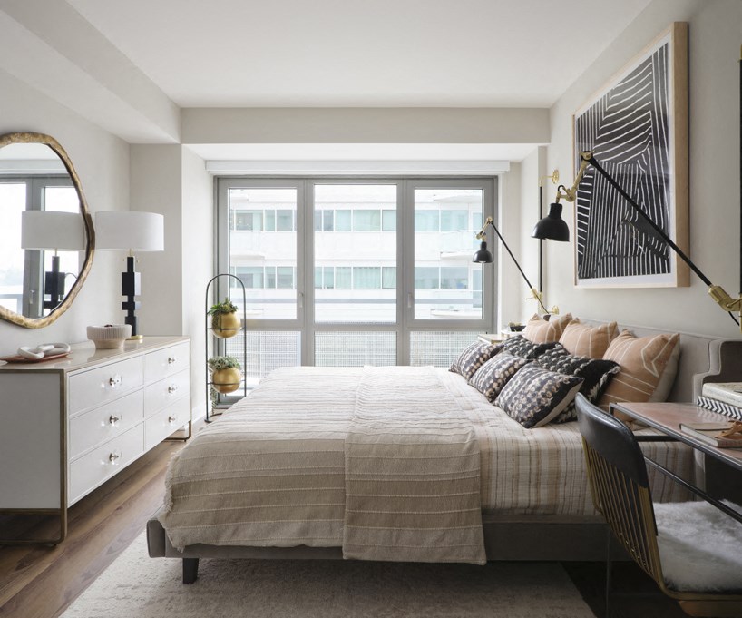 a bedroom with a bed and a large window