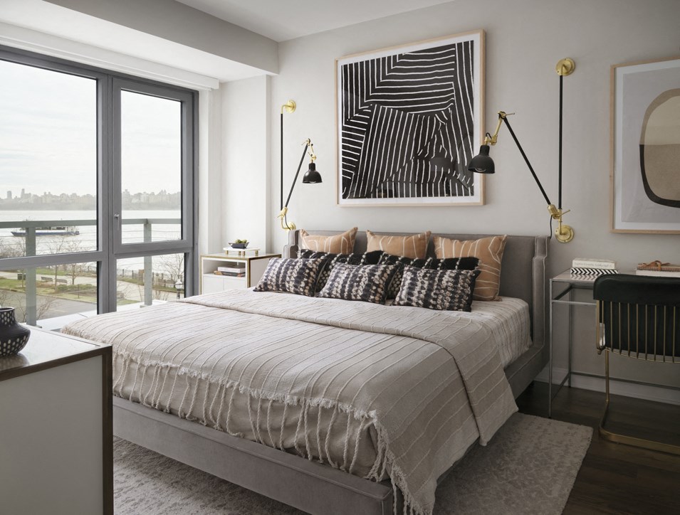 a bedroom with a large bed and a view of the water