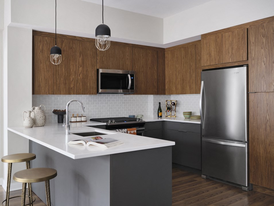 a kitchen with stainless steel appliances and a white counter top