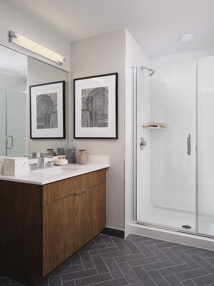 a bathroom with a shower and a sink and a mirror