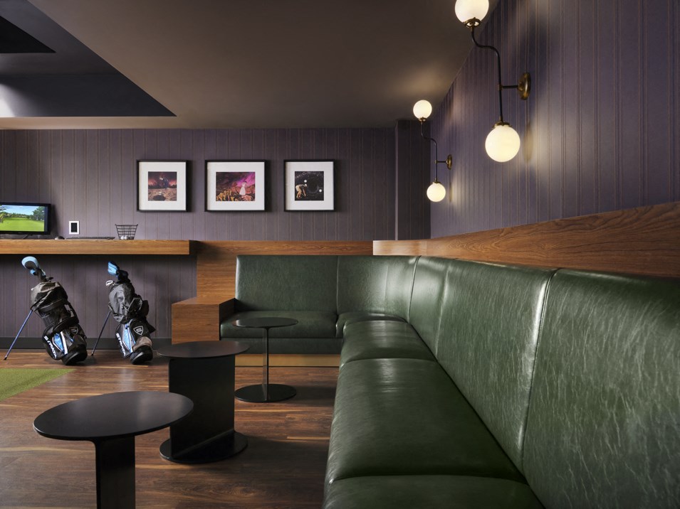 a living room with a green couch and a table