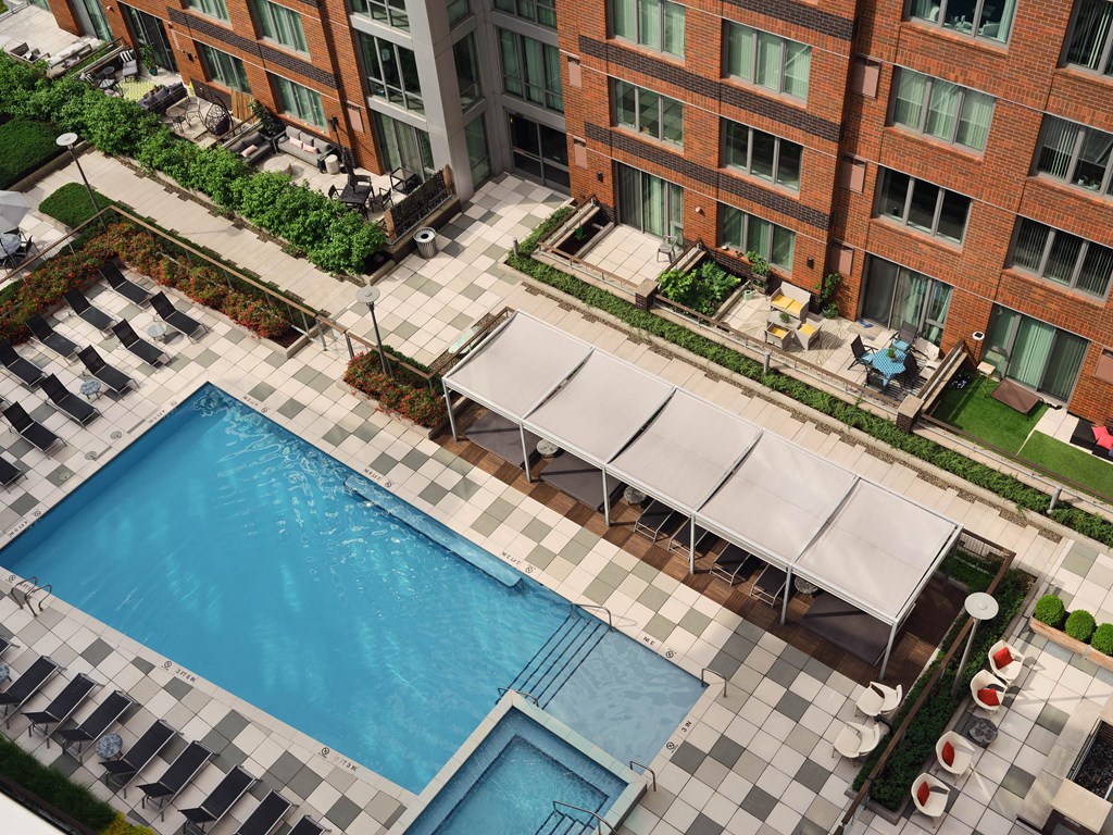 an aerial view of a swimming pool in front of a building