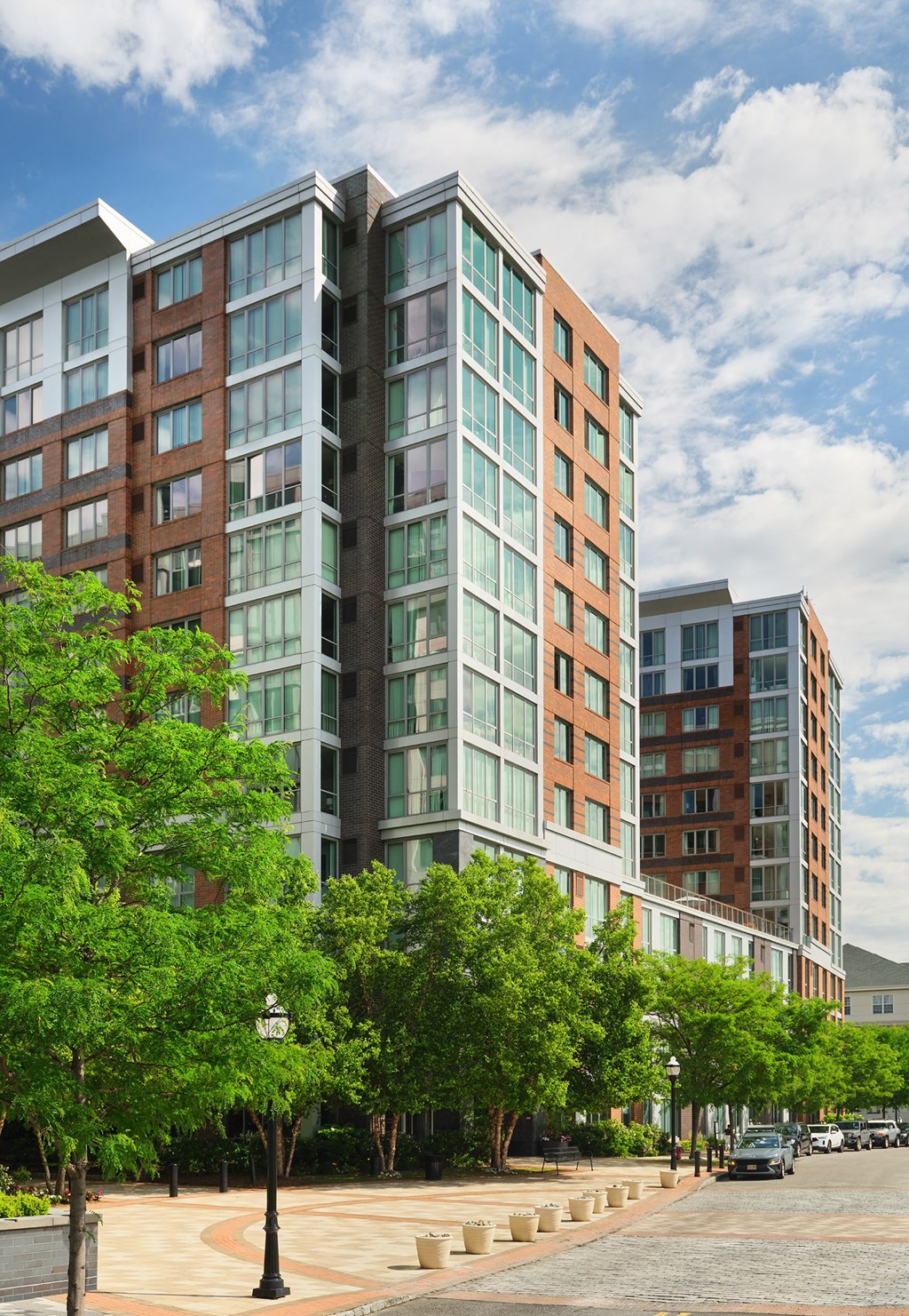 a tall building with trees in front of it on a city street