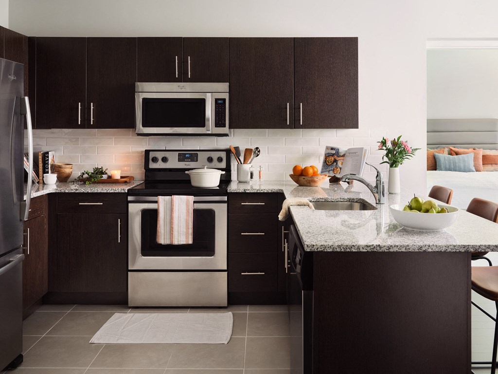 a kitchen with stainless steel appliances and granite counter tops