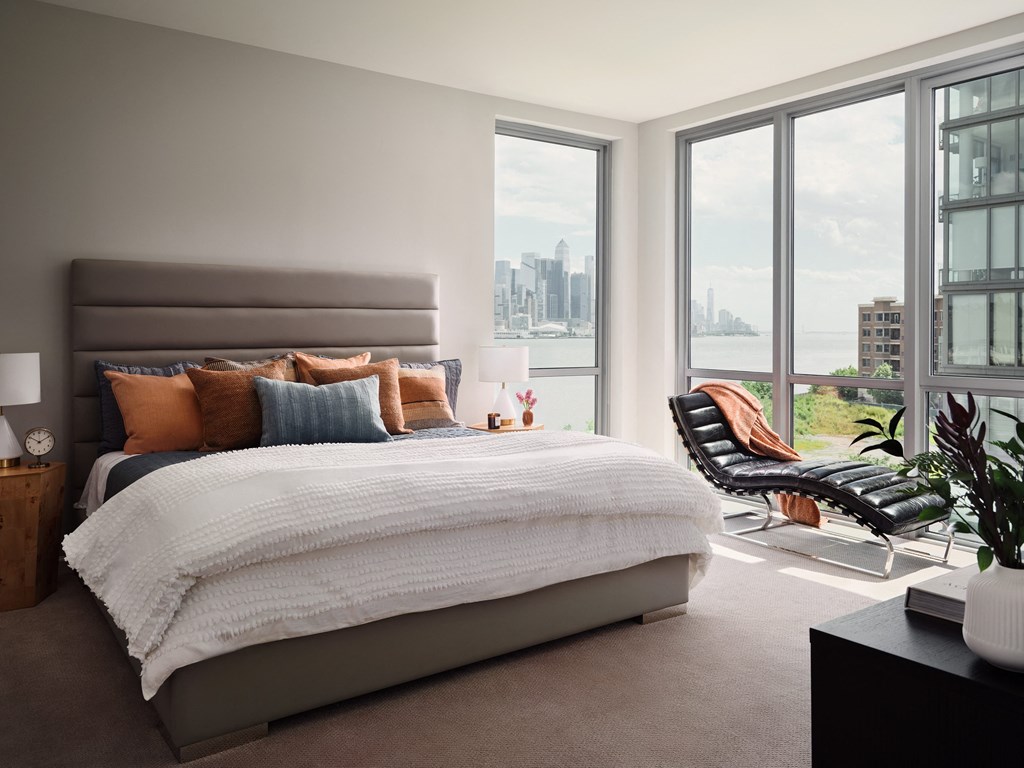 a bedroom with a bed and a view of the city