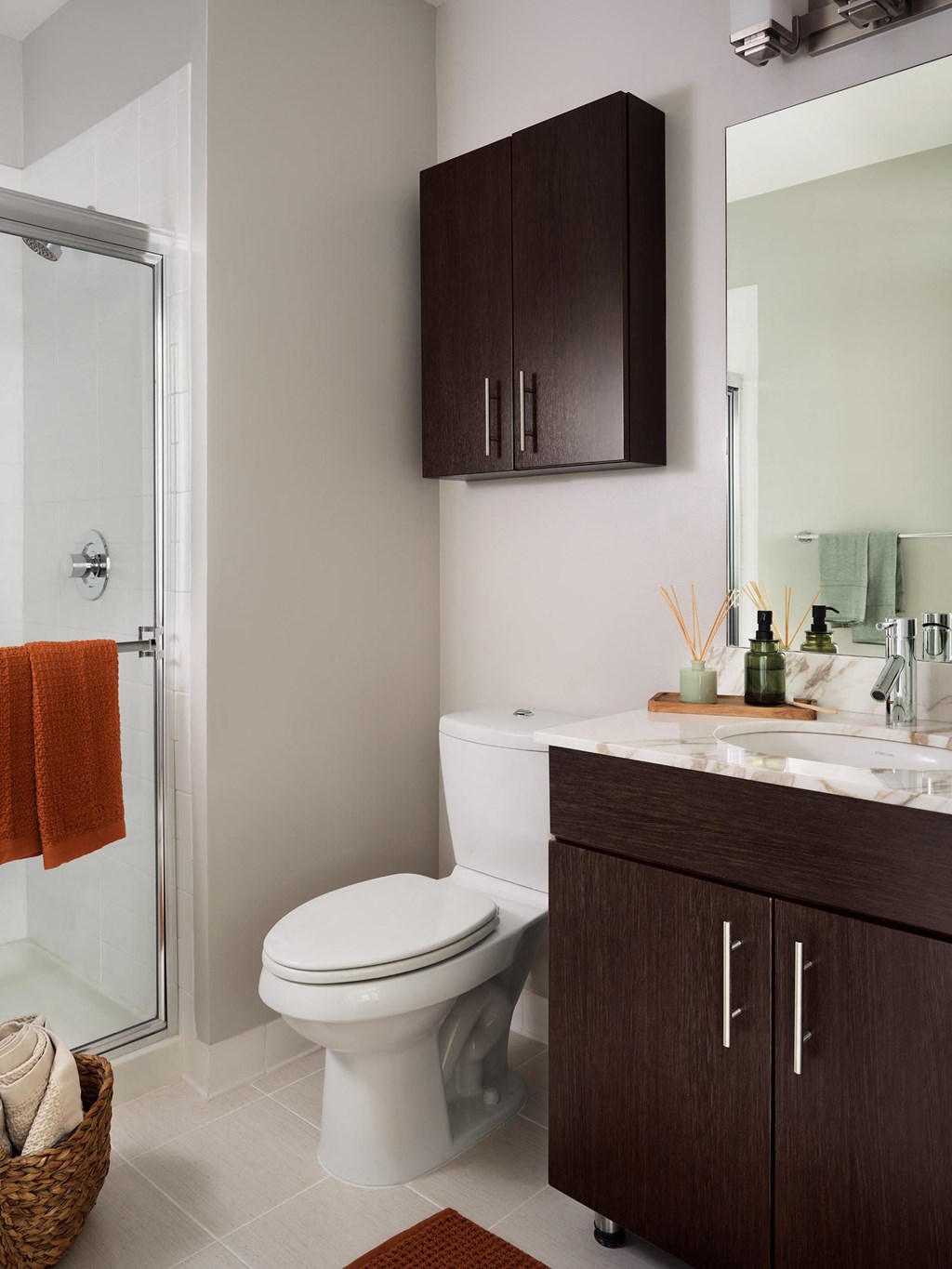 a bathroom with a toilet and a sink and a shower