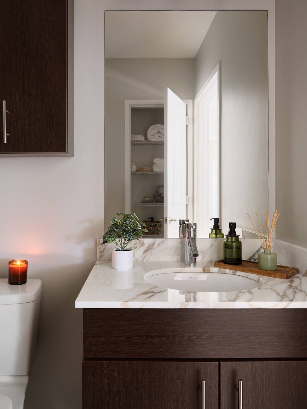 a bathroom with a white sink and a mirror
