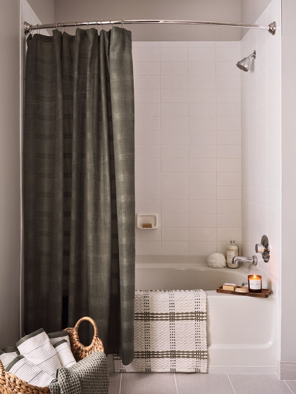 a small bathroom with a tub and a shower curtain