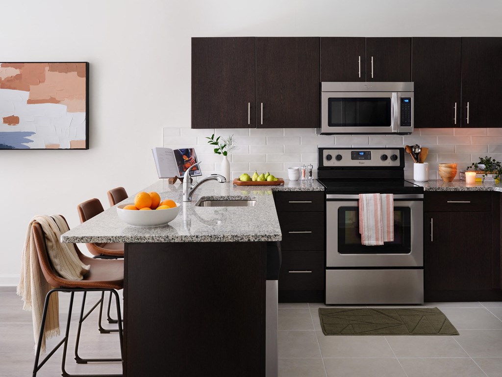 a kitchen with stainless steel appliances and a granite counter top