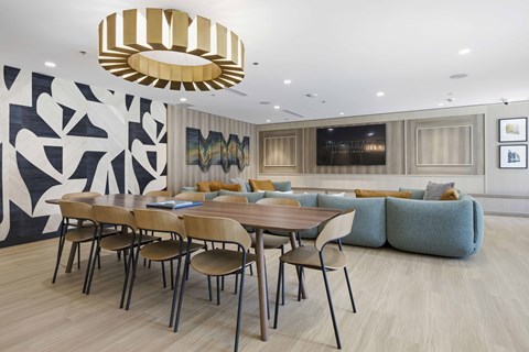 A modern dining room with a large table and chairs.