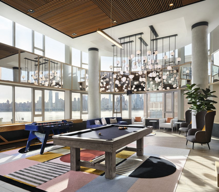 a large room with a pool table and large windows