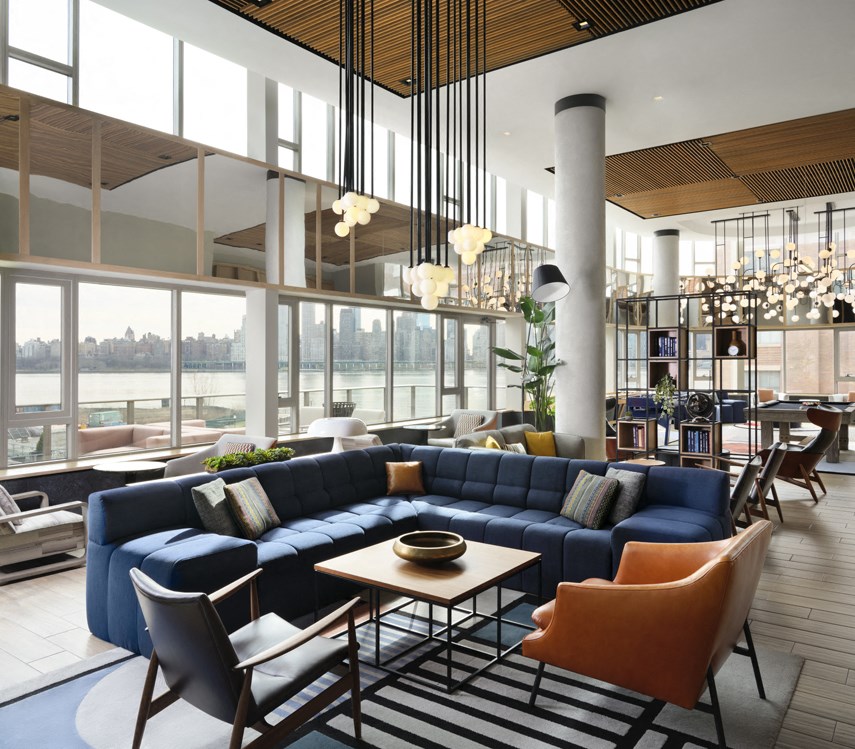 a large living room with blue couches and chairs and a table