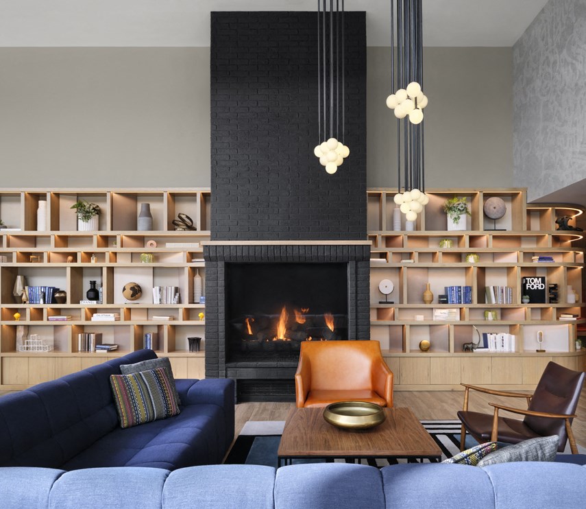 a living room with blue furniture and a fireplace