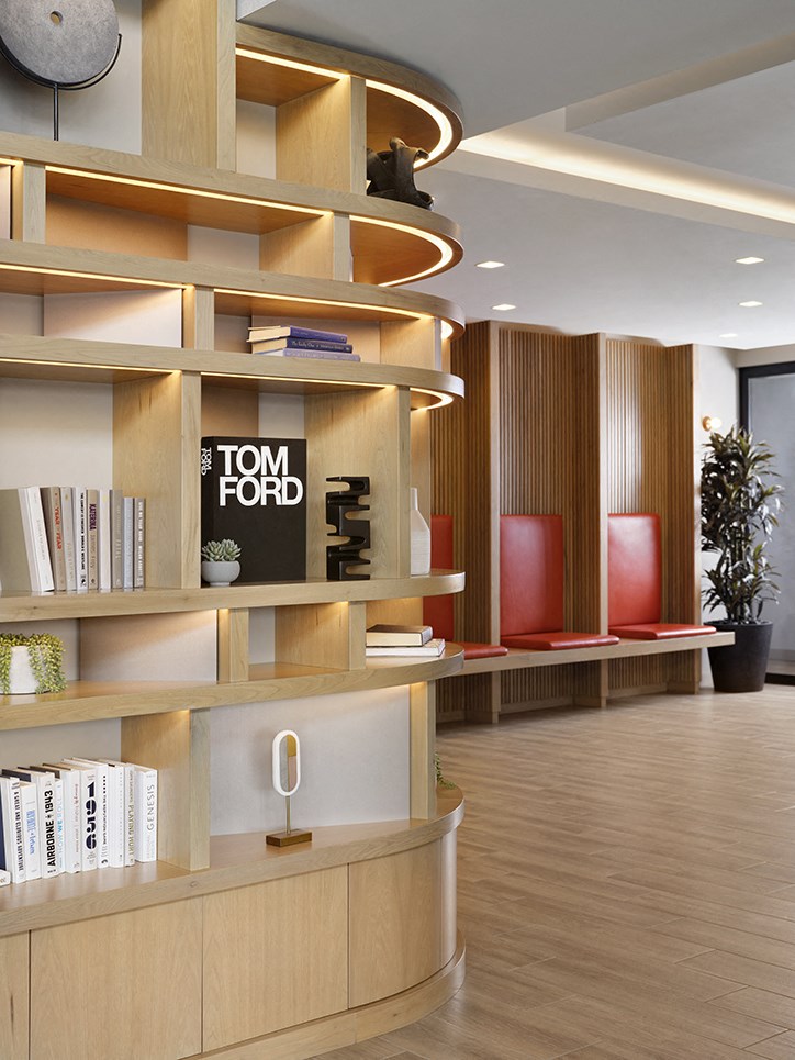 a reception area with wood shelving and a sign that reads