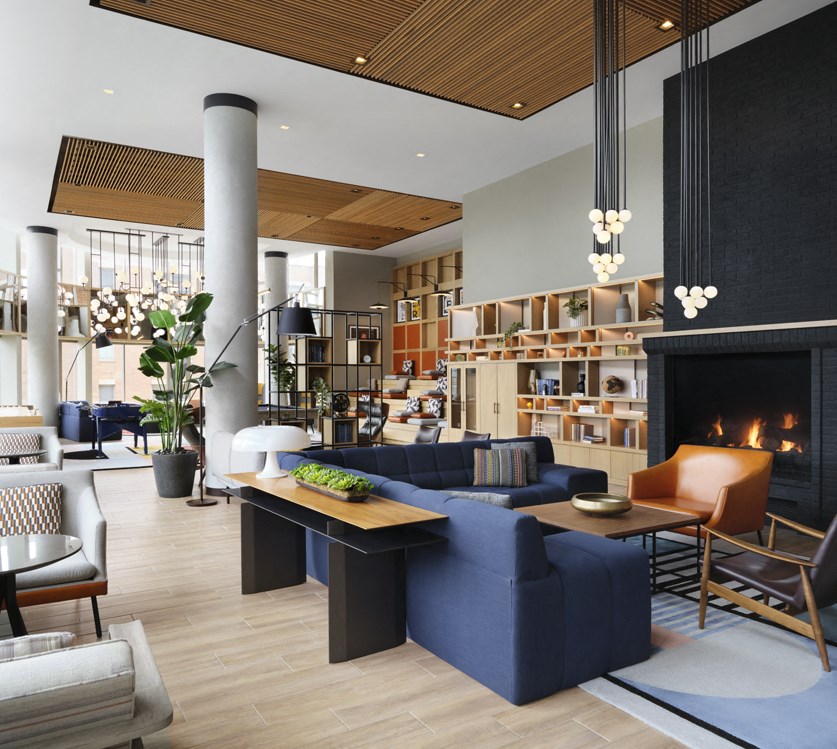 a living room with couches and chairs and a fireplace