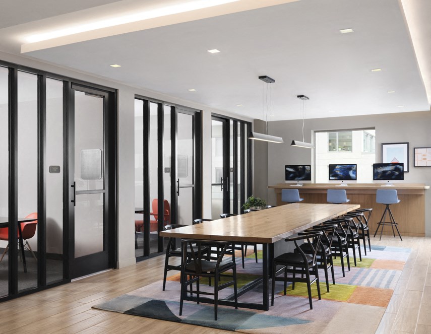 a conference room with a long wooden table and chairs