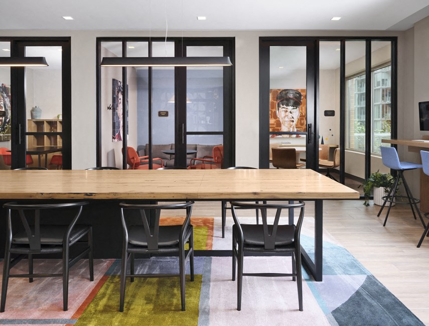 a dining room with a large wooden table and chairs