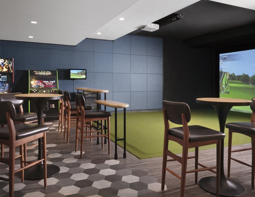 a sports bar with tables and chairs and a tv on the wall