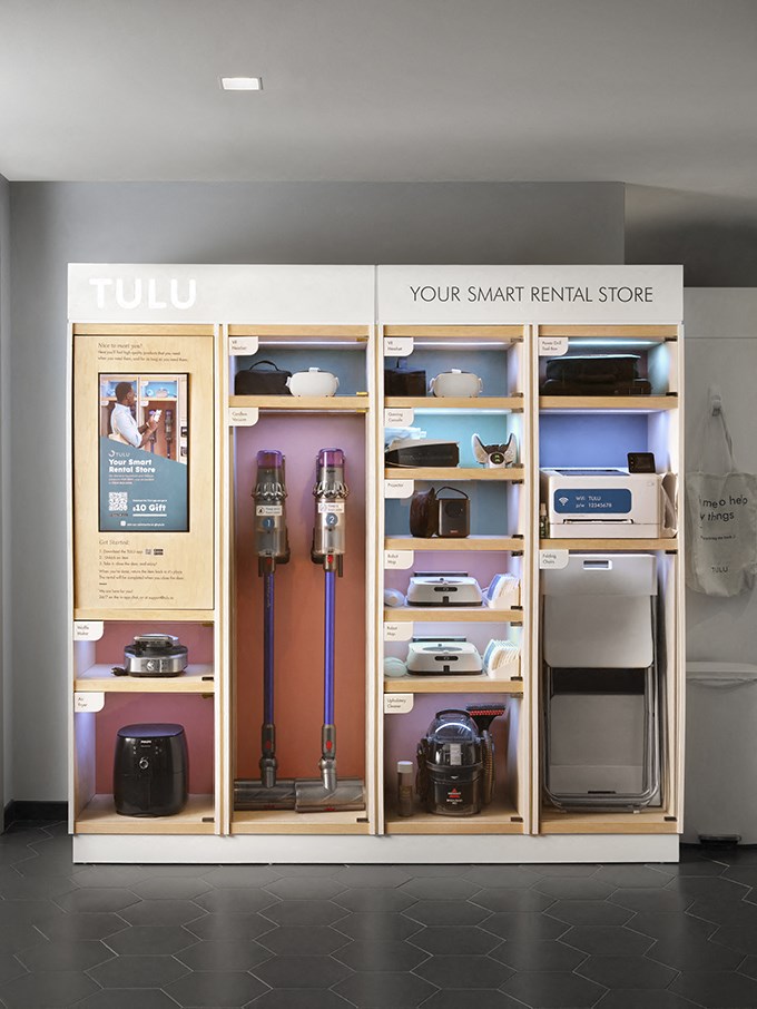 a display case with refrigerators and other appliances in a room