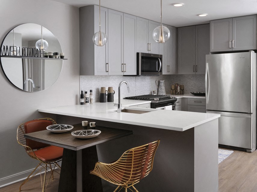 a kitchen with stainless steel appliances and a white counter top