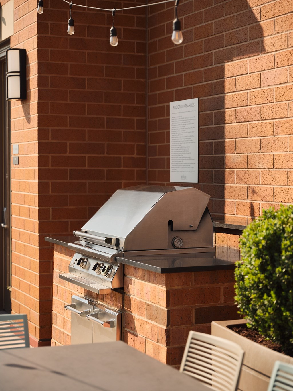 a barbecue grill on the side of a brick building