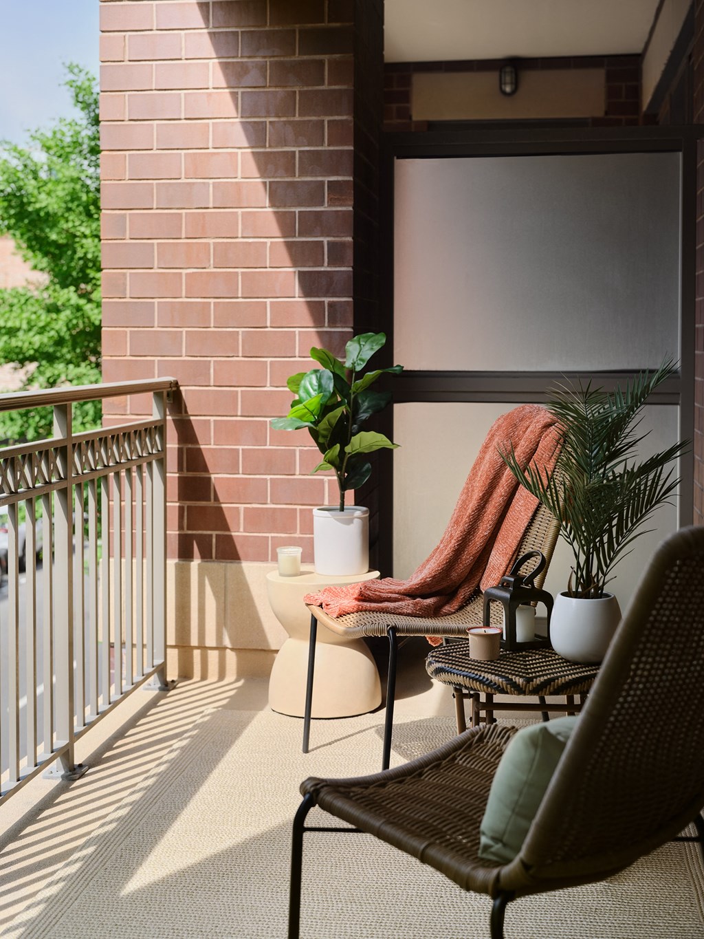 a balcony with a chair and a table and some plants