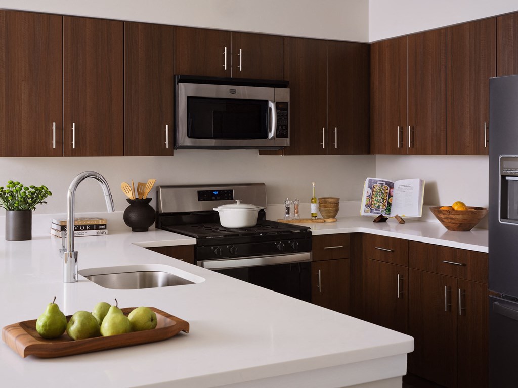 a kitchen with a white counter top and a sink