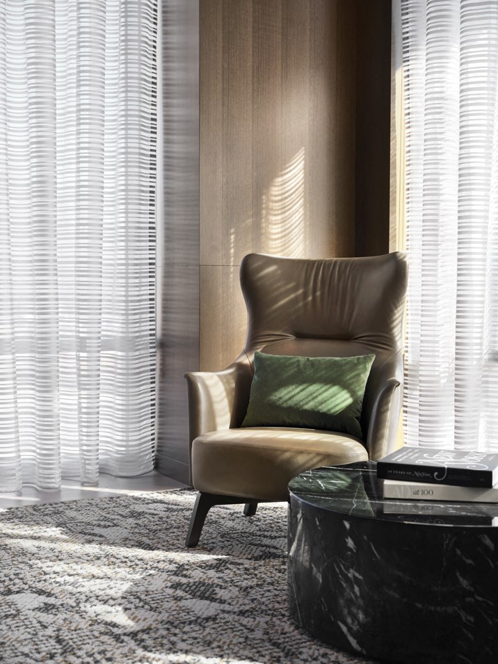 a chair with a green pillow in a room