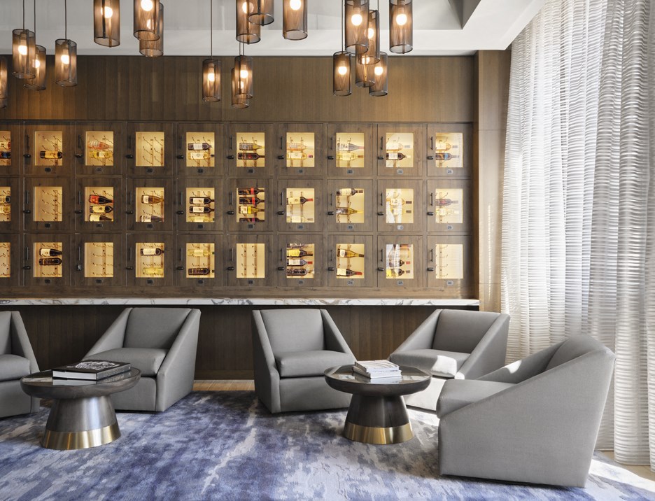 a lobby with couches and tables and a wall of watches