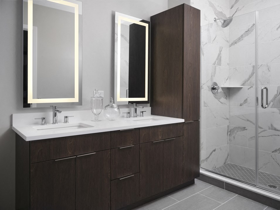 a bathroom with a sink and two mirrors and a shower