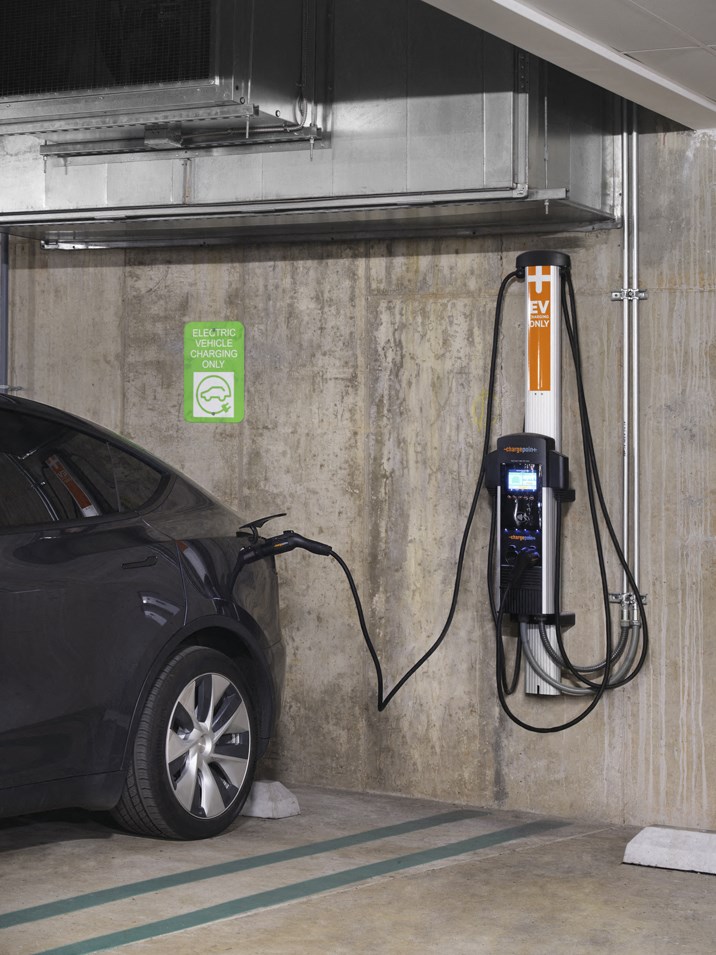 an electric car plugged in to a charging station in a garage