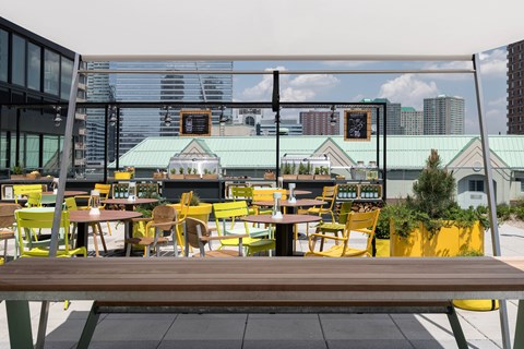 A yellow chair is in front of a table.