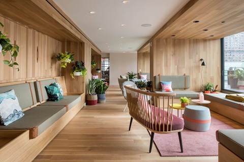 A modern living room with wooden walls and furniture.
