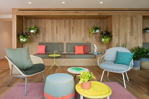 A living room with a grey chair and a yellow table.