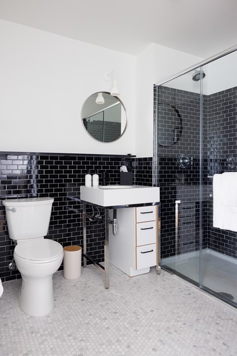A white toilet sits next to a sink in a bathroom.