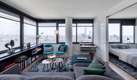 A living room with a view of the city skyline.