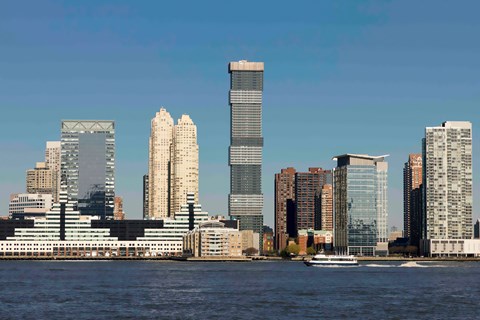A city skyline with a body of water in front of it.