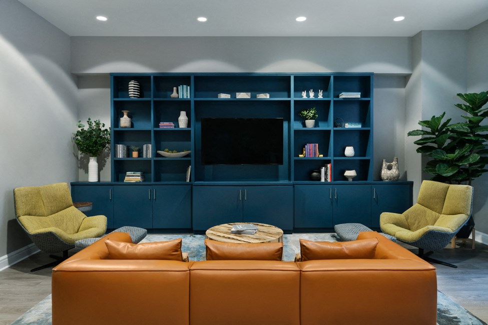 a living room with a couch and chairs and a television