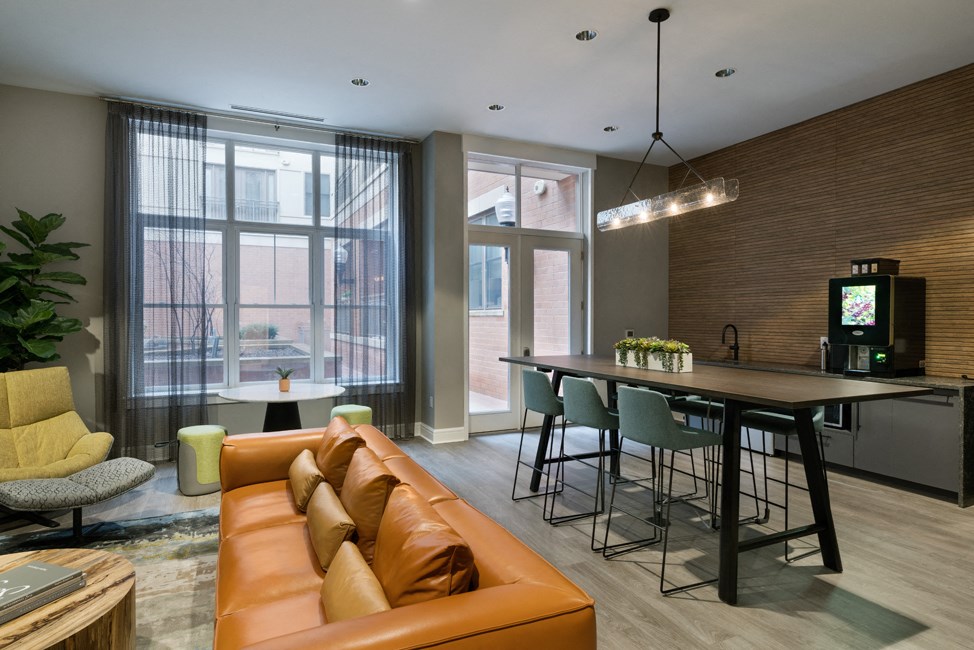 a living room with a couch and a table with chairs