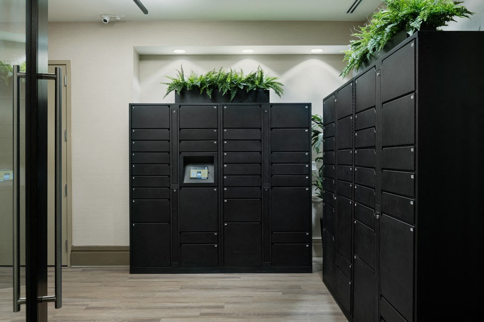 a row of black lockers with plants on top of them